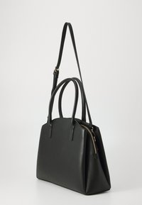 Black leather handbag with dual handles, a detachable strap, and a zip closure. Features a structured design and smooth texture.