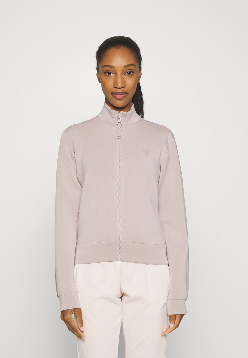 Light pink zip-up jacket with a high collar, ribbed cuffs and hem, featuring a small logo on the chest. Smooth fabric texture.