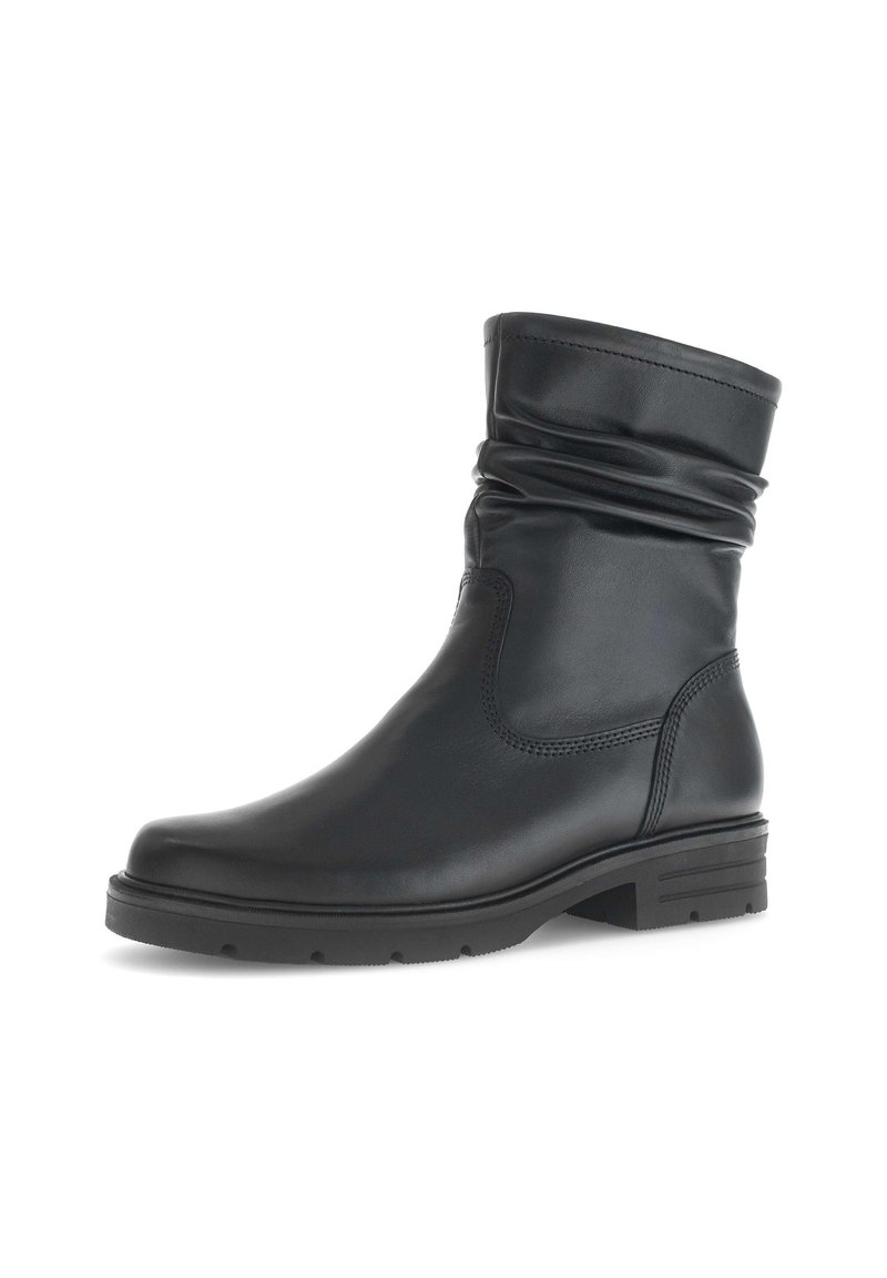 Black leather ankle boot with a slouchy top, rounded toe, and textured sole. Features minimalist stitching and a low, block heel.