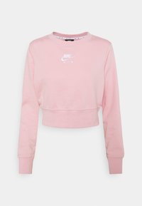 Felpa corta rosa realizzata in tessuto morbido. Presenta maniche lunghe e un collo rotondo con il logo bianco Nike Air sulla parte anteriore.