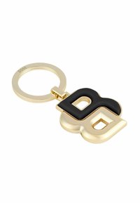 Gold keychain featuring interlocking black and gold letters 'B' and 'G'. Smooth finish with a glossy texture, attached to a circular ring.