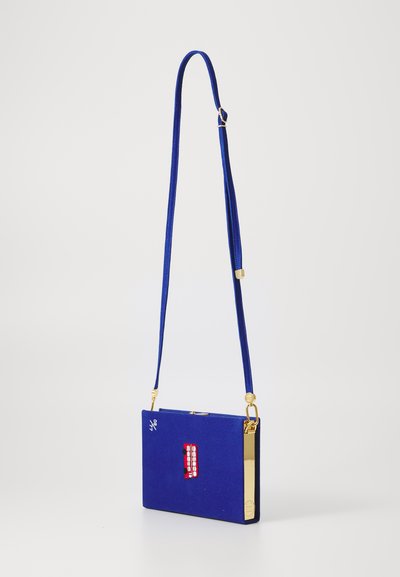Blue velvet crossbody bag with a rectangle shape, gold hardware, a graphic red design, and a long adjustable strap.