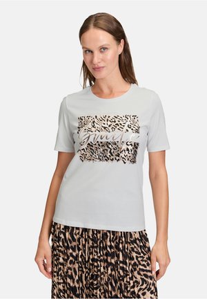 Light gray t-shirt with short sleeves featuring a leopard pattern graphic and metallic lettering "Genuine" on the front.