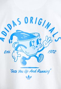 Λευκό T-shirt με μπλε καρτούν κούπα χαρακτήρα που έχει χέρια και πόδια, και κείμενο "ADIDAS ORIGINALS" και "Σε Σηκώνει Και Σε Βάζει Να Τρέξεις."