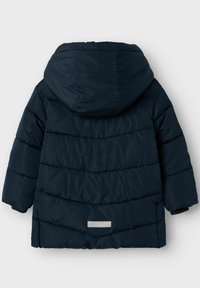 Navy blue puffer jacket with a hood, featuring horizontal quilted sections, elastic cuffs, and a reflective accent on the back hem.