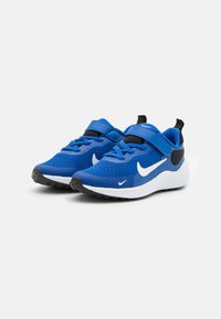 Zapatillas deportivas azules con parte superior de malla, detalles en negro y el swoosh blanco de Nike. Cuentan con una correa ajustable y una suela de goma texturizada.