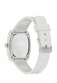 Ruudukujuline valge kell silikoonriba, roostevabast terasest tagumine osa ja hõbedased viimistlused. Tagaküljel on kujutatud Adidas logo.