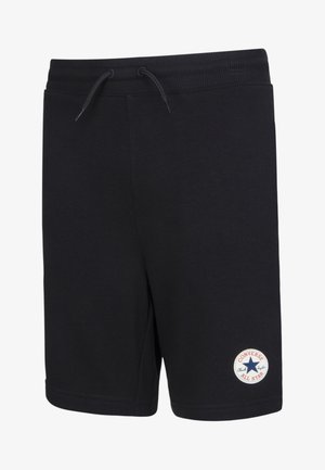 Calções pretos de algodão com um cós elástico, cordão ajustável e um patch redondo branco com o logo "Converse All Star" na perna esquerda.