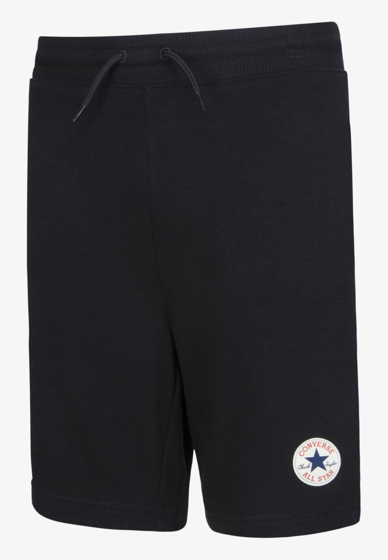 Shorts en coton noir avec une taille élastique, cordon de serrage ajustable et un patch rond blanc "Converse All Star" sur la jambe gauche.