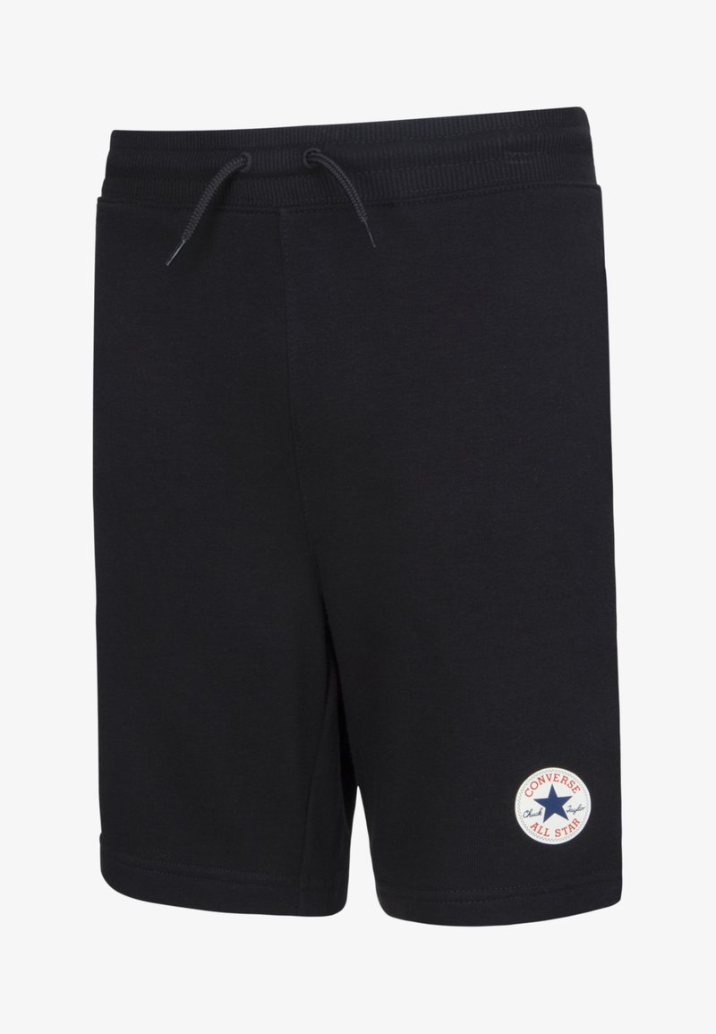 Calções pretos de algodão com um cós elástico, cordão ajustável e um patch redondo branco com o logo "Converse All Star" na perna esquerda.