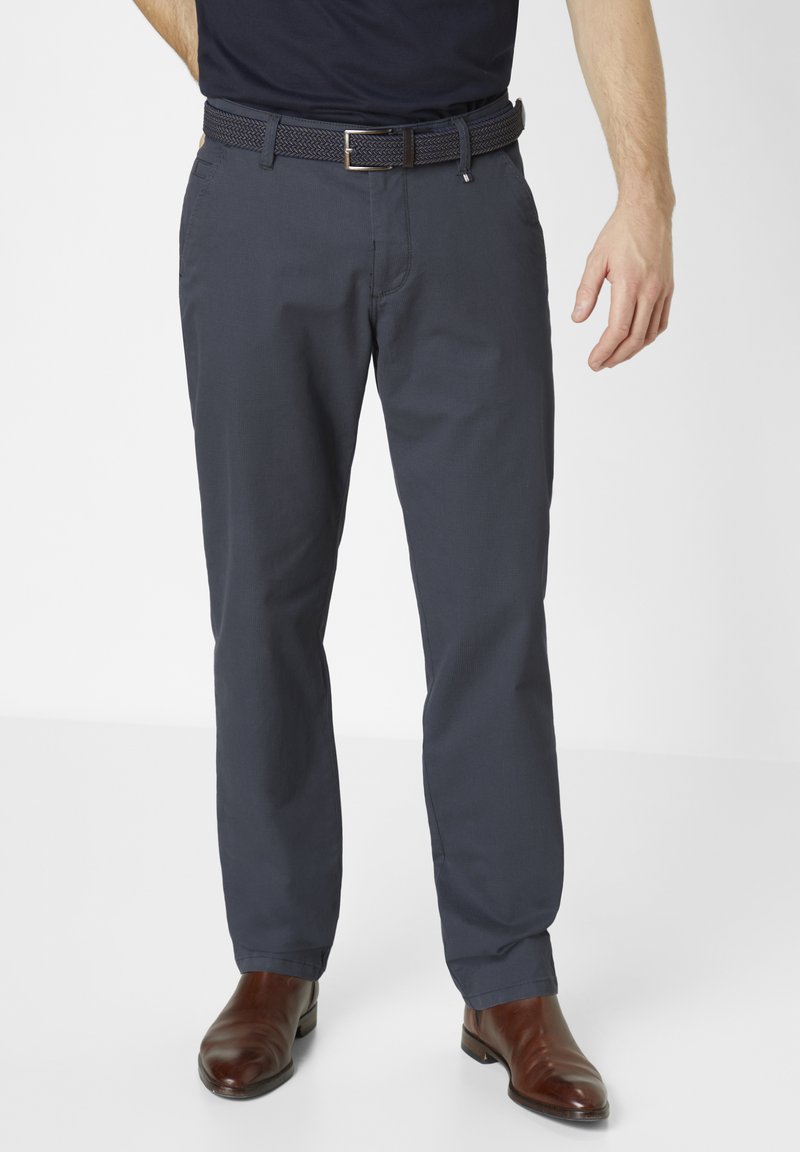 Navy blue woven belt with silver metal buckle, paired with gray dress pants, featuring a smooth texture and tailored fit, worn with brown leather boots.