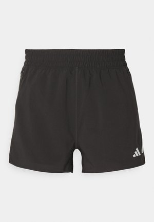 Shorts de sport noirs en tissu léger. Dotés d'une taille élastique, d'une poche zippée sur le côté et d'un logo réfléchissant sur l'ourlet.