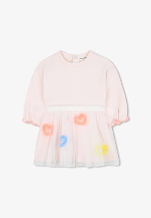 Haut en coton rose avec des manches courtes bouffantes, présentant une superposition en tulle transparent ornée de pompons ronds colorés et d'une ceinture décorative.