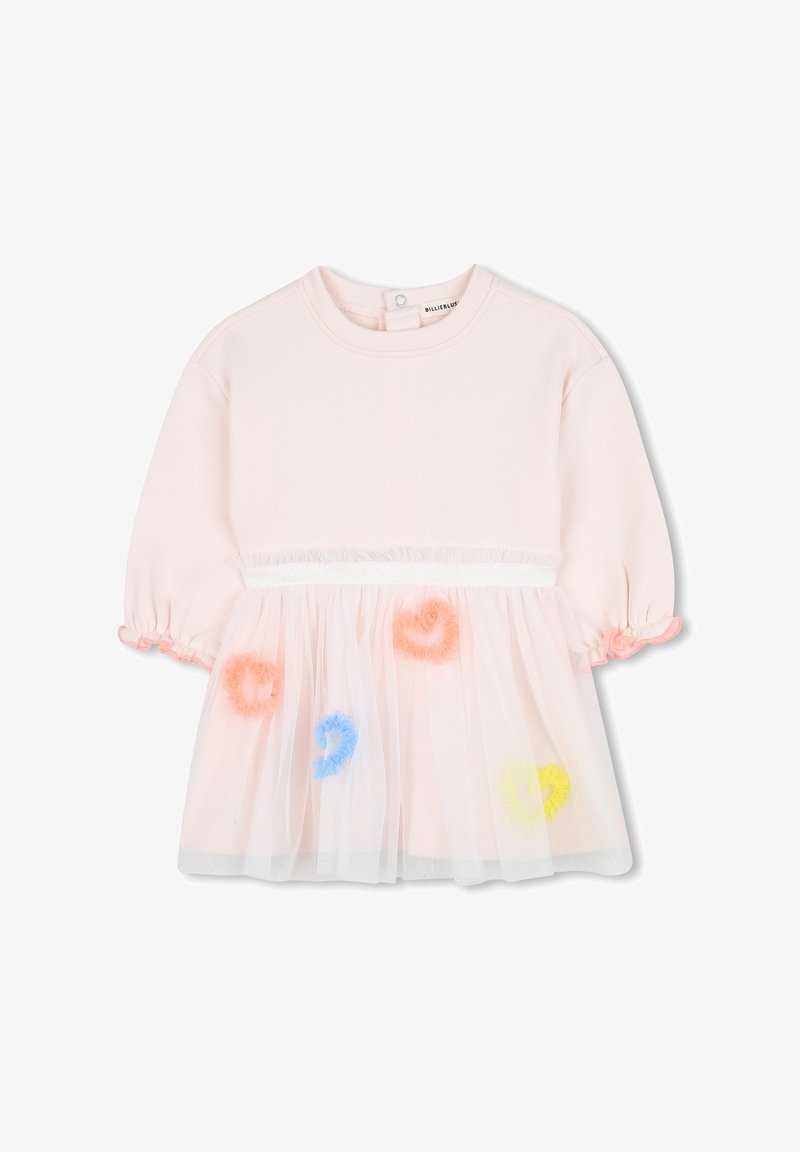 Haut en coton rose avec des manches courtes bouffantes, présentant une superposition en tulle transparent ornée de pompons ronds colorés et d'une ceinture décorative.