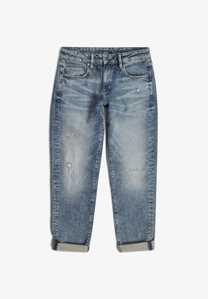 Lys blå denimjeans med en avslappet passform, slitte detaljer og oppbrettede sømmer. Har tradisjonelle lommer og glidelås.