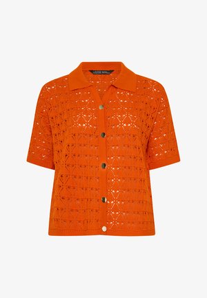 Cárdigan de manga corta en naranja brillante con cuello camisero, cierre de botones y un patrón geométrico de punto calado.