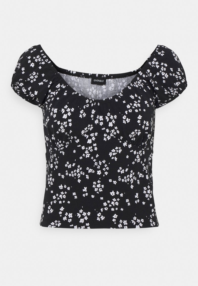 Musta kapeasti istuva lyhythihainen paita, jossa on puffihihet ja pieni valkoinen kukkakuosi.