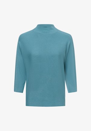 Turquoise oversized trui met een hoge hals, 3/4 mouwen en een ribbelstructuur, met zijsplitten voor gemakkelijk bewegen.