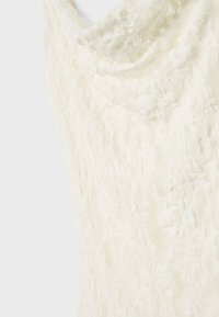 Textured cream fabric, draped design with a cowl neckline, featuring a crinkled surface. Soft material with a subtle sheen.