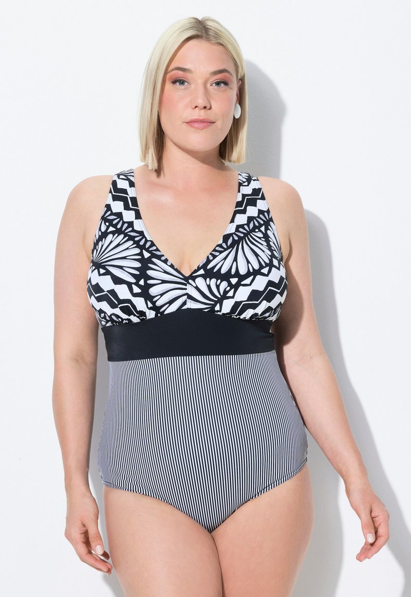 Maillot de bain noir et blanc avec un motif floral et en zigzag sur le haut, accompagné d'une bande noire unie et d'une texture rayée sur la partie inférieure.