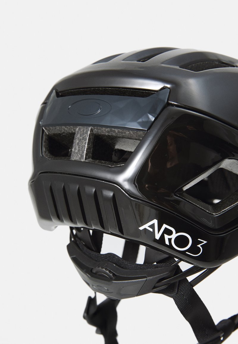 Black helmet with ventilation holes, sleek design, ARO3 branding, and adjustable straps. Smooth texture with a glossy finish.