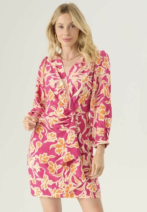 Pink floral dress with orange and cream patterns, wrap design, long sleeves, gathered waist, and smooth texture.