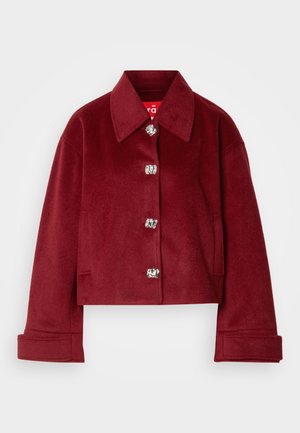 Burgundy cropped jacket in wool blend, featuring a collar, silver snap buttons, and side pockets; smooth texture with a tailored fit.