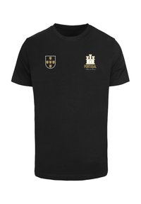 Sort bomulds T-shirt med et våbenskjold med syv skjolde på venstre bryst og et slotgrafik med "PORTUGAL" i guld på højre side.