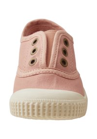Pink canvas slip-on shoes with a textured upper, featuring metal eyelets, a low-profile rubber sole, and a smooth, rounded toe.