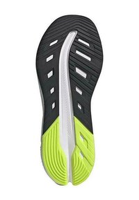 Suela de zapato de goma con parte superior negra, sección media blanca y acentos en verde brillante. Presenta textura estriada y cortes estratégicamente ubicados.