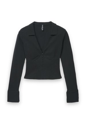 Blouse noire crop top à manches longues avec larges poignets, col en V profond, taille structurée et petites fermetures à crochet à l'avant.