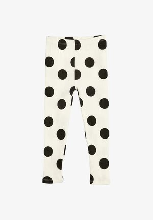 Weiße, gerippte Leggings mit großen schwarzen Punkten, die gleichmäßig auf dem Stoff verteilt sind, flach gezeigt aus Vorderansicht.