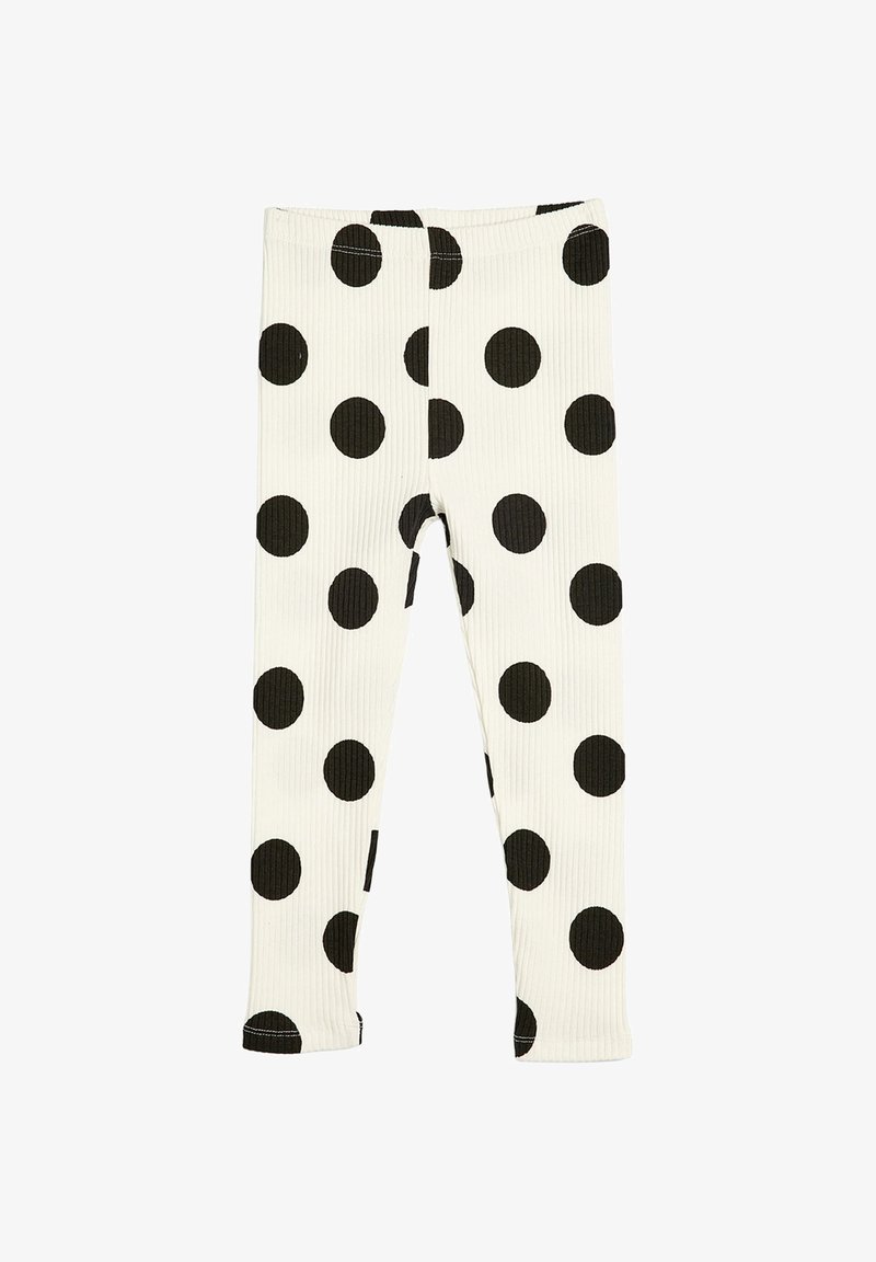 Leggings blancs côtelés avec de grands pois noirs uniformément répartis sur le tissu, présentés à plat avec une vue de face.