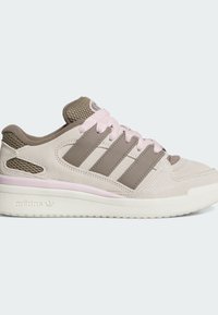 Light beige athletic shoe with mesh and suede materials, brown accents, pink laces, and three stripes on the side. Rubber sole.