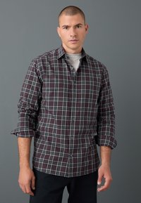 Checked button-up shirt in dark purple and gray tones. Soft fabric with long sleeves, folded cuffs, and a classic collar.
