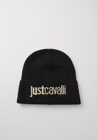 Črna pletena kapa z zavihkom, ki ima na sprednji strani zlato vezeno besedilo "Justcavalli", celotna površina pa je rebrasta.