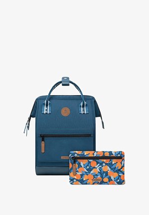 Blue backpack with a textured finish, featuring a top handle, front zip pocket, and a floral-patterned pouch with orange and blue accents.