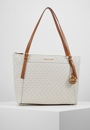 Sac cabas beige et marron Michael Kors avec motif monogramme MK, bandoulières réglables et breloque logo MK dorée sur une surface blanche.
