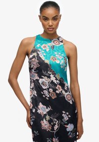 Sukienka w kwiatowy wzór z turkusowym górnym fragmentem i czarną spódnicą. Satynowa tekstura z misternymi wzorami oraz dopasowany krój.