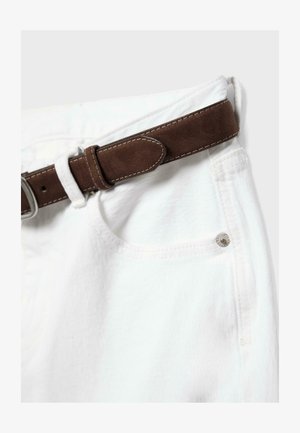 Close-up of white denim pants with a brown suede belt threaded through the waistband and metal button detail.
