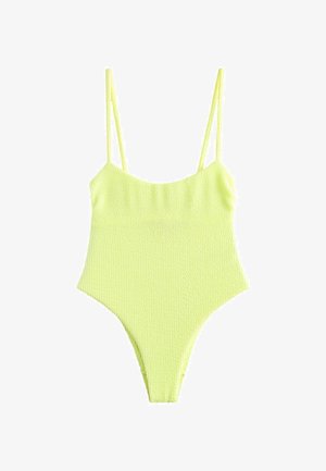 Bañador de una pieza color amarillo neón con tela texturizada, tirantes delgados y diseño de pierna de corte alto. Cuenta con un escote redondo y cobertura mínima.
