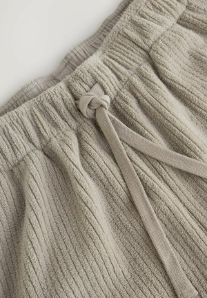 Khaki cotton shorts with a textured ribbed pattern. Features an elastic waistband and a fabric tie for adjustment. Soft, plush material.