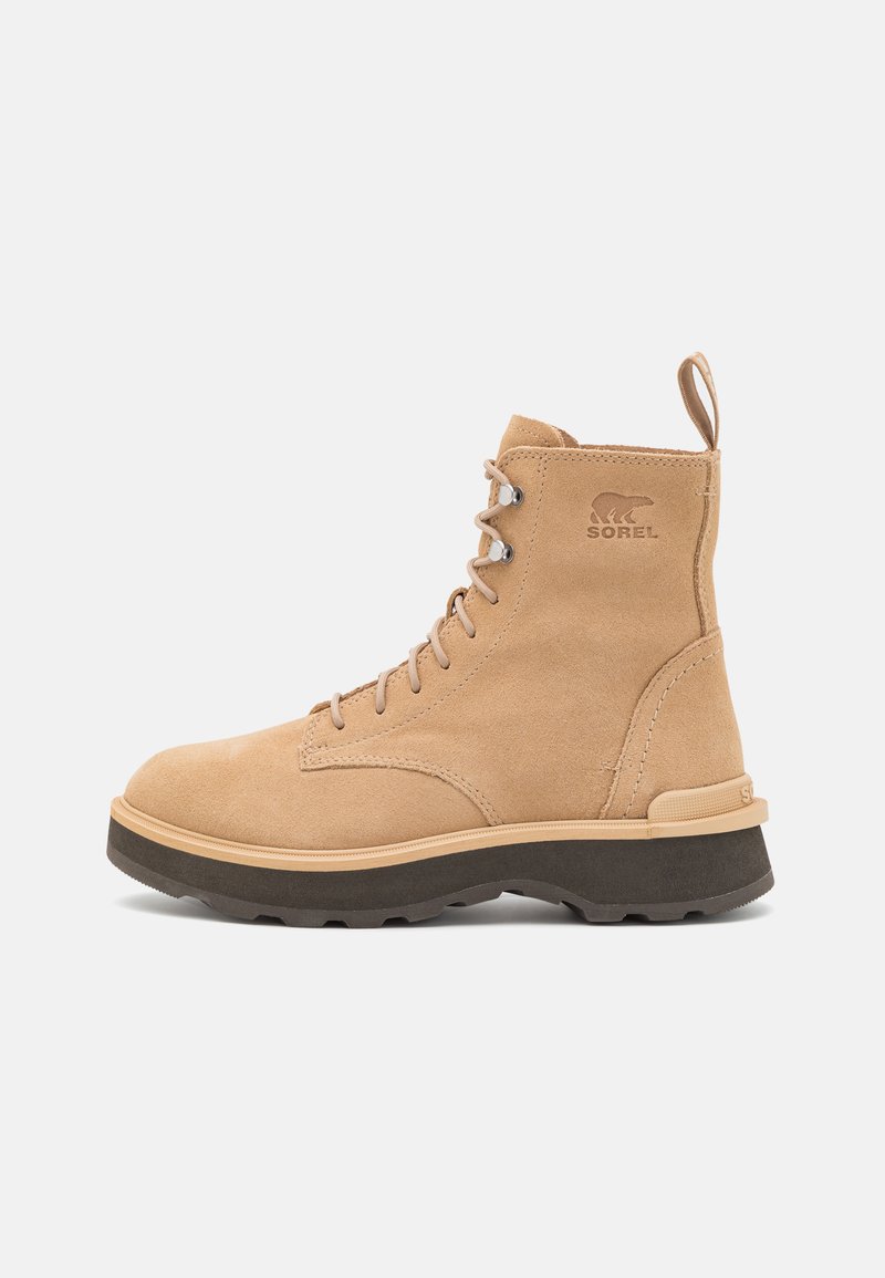 Cremfarbene Wildleder-Ankle Boots mit Schnürdesign, verstärkter Zehenkappe, kontrastierender Gummisohle und Schlaufe an der Ferse für ein einfaches Anziehen.