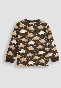 Chemise à manches longues marron avec un imprimé de dinosaures en crème et beige. Dotée d'un col rond et de poignets côtelés. Matériau en coton doux.