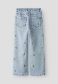 Hele sinise värvusega teksapüksid laiade säärtega, millel on lilleline tikand kangal, viis taskut ja sirge äärega.