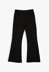 Schwarze Schlagleggings aus dehnbarem Baumwollstoff mit elastischem Bund. Die Hose hat eine glatte Textur und ein schlichtes Design.