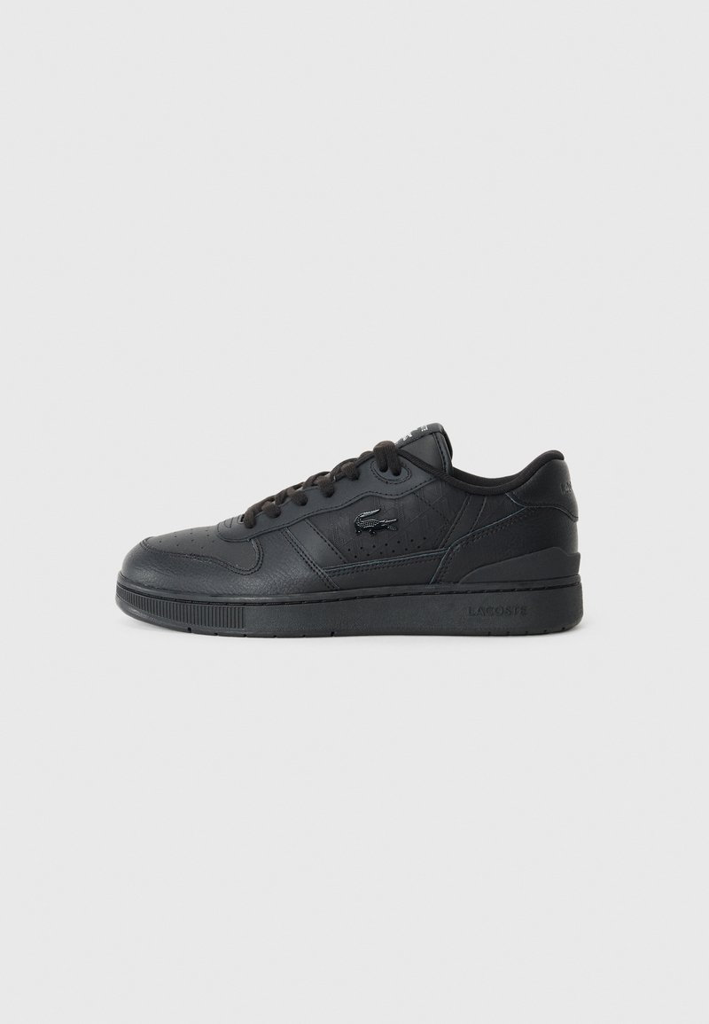 Black leather sneaker with a low-top design, textured surfaces, lace-up closure, and a logo on the side. Features a rubber sole.