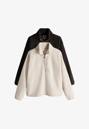 Fleece-tröjset med kvartszipsdesign. En i vitt, en i svart. Mjuk textur, avslappnad passform och ståkrage.