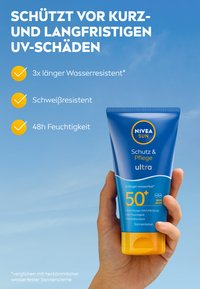 NIVEA Sun sunscreen in a blue tube with a yellow cap, labeled "50+" and "ultra." Features UV protection and moisture claims, held in a hand.