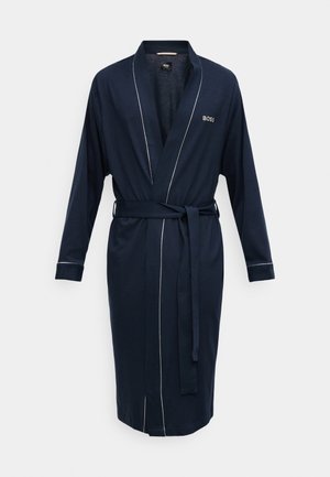 Peignoir bleu marine en tissu doux, doté de manches longues et d'une ceinture à nouer. Un passepoil blanc orne le col et les poignets pour plus de détails. Logo de la marque visible.